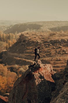 A hiker conquers rough terrain in İncesu, Kayseri, showcasing adventure and nature.