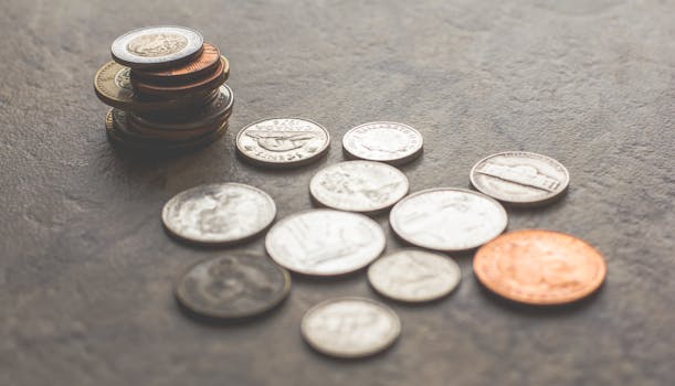 Assorted foreign coins stacked and scattered on a textured surface.