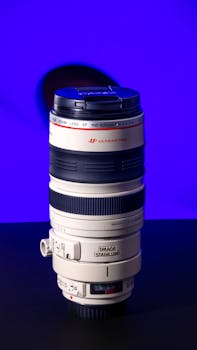 Detailed shot of a professional camera lens with a vibrant blue backdrop.